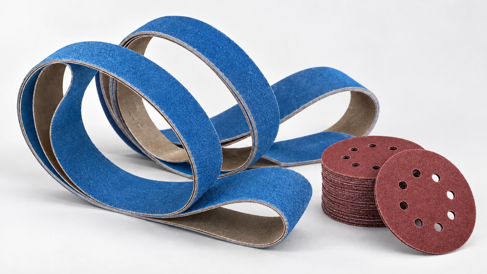Blue custom sanding belts with red aluminum oxide perforated sanding discs